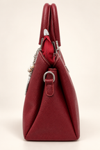 Gia Sling burgundy side profile showing textured PU leather, structured triangular shape, top handles and silver-tone strap attachment