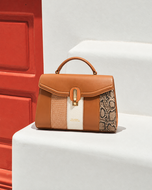 Bela Sling front view in caramel brown with textured panels, snakeskin side detailing and gold-tone clasp | variant:brown