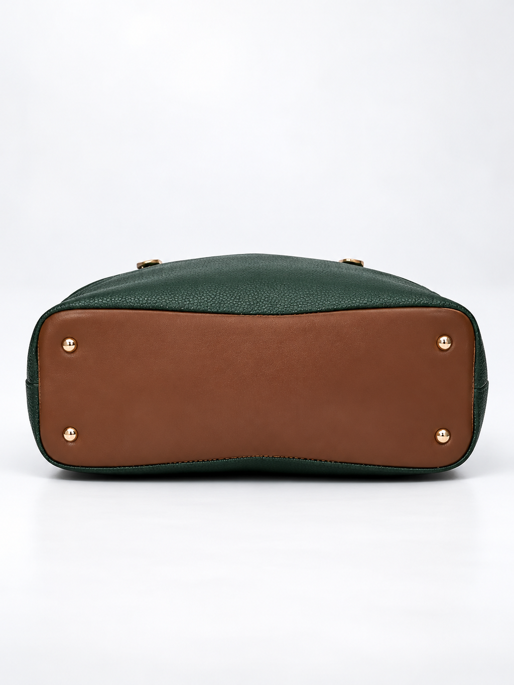 Modern Hola Shoulder Bag bottom view in forest green featuring a brown base panel, four gold-tone protective feet and pebbled PU leather edges